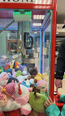 Father, child enjoy claw machine games at Chaikovsky store