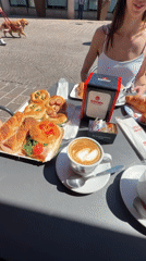 Women dine at outdoor cafe in Corsico square
