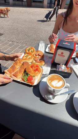 Women dine at outdoor cafe in Corsico square