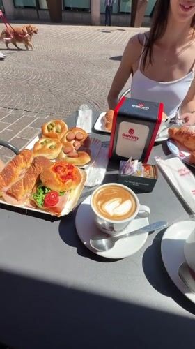 Women dine at outdoor cafe in Corsico square