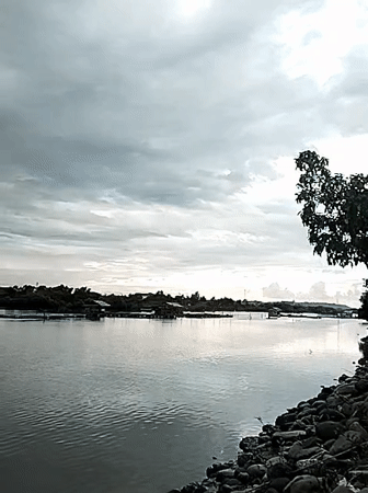 Quiet coastal morning in Lhokseumawe — water, fishing, and street life