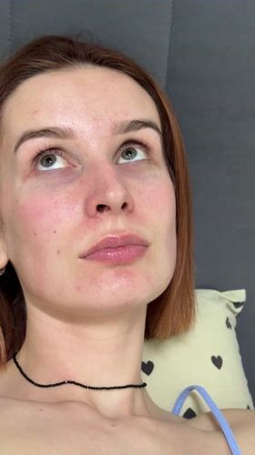 Woman documents skincare routine with pets in Chaikovsky home