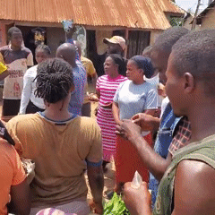 Group gathers outdoors with microphone near green plants
