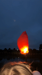 Heart-shaped sky lantern released at a dusk celebration in Karsha