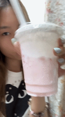 Woman takes selfies, drinks pink beverage in Chongqing bedroom