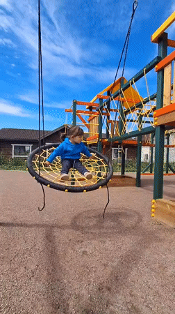 Child plays on playground equipment and stuffed animals in Russia