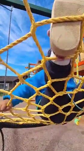 Child plays on playground equipment and stuffed animals in Russia