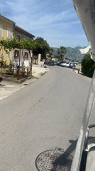 Small transport vehicle carries passengers through Montenegro seaside town