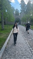 Pedestrians walk through historic Vyborg district near Catholic church