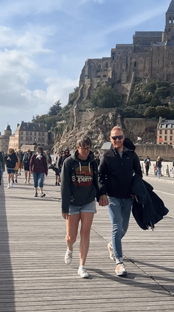 Tourists explore Mont Saint-Michel abbey on sunny afternoon