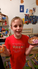 Boy shows off handmade crafts in bedroom