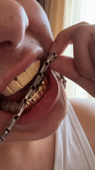 Person showcases gold grillz, writes on iPad, handles video games