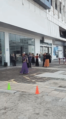 Late-night square dancing group performs near Chongqing Cadillac dealership