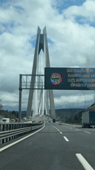 Vehicle approaches suspension bridge on Turkish highway