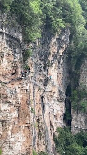 Tourists explore Zhangjiajie glass bridge during early morning visit
