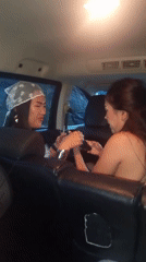 Two women travel in car backseat in Kuta Selatan