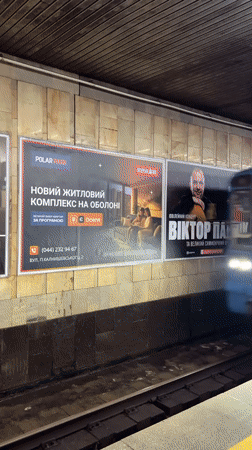 Blue-yellow train passes through Kyiv subway station
