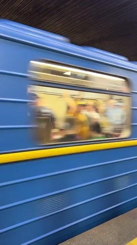 Blue-yellow train passes through Kyiv subway station