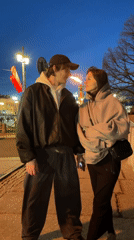 Couple visits St. Petersburg's Rostral Columns at twilight