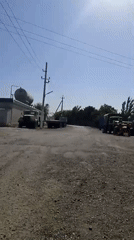 Quiet roadside scene with parked vehicles and long shadows