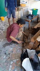 Construction work and debris clearance at a Banjarmasin waterside site