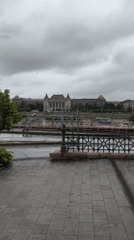 Wet walkway view captures Budapest riverside architecture