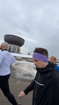 Morning joggers run along Kazan riverfront pathway