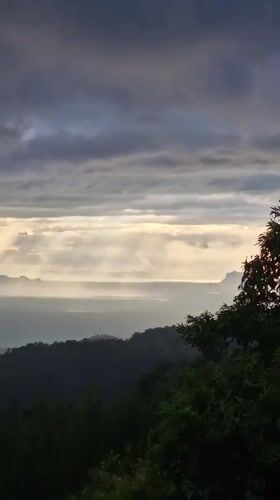 Storm clouds gather over Ko Samui as locals navigate rural roads