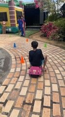 Child plays on toy car course in Porlamar