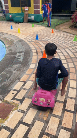 Child plays on toy car course in Porlamar