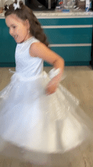 Girl in white dress plays in kitchen, Izhevsk