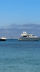 Children play in calm Antibes waters on sunny spring day