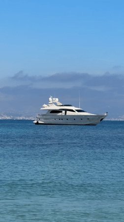 Children play in calm Antibes waters on sunny spring day
