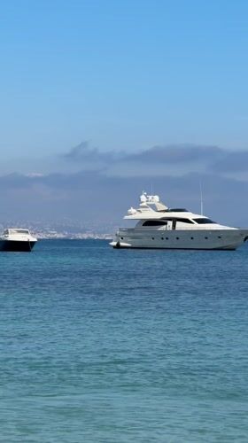 Children play in calm Antibes waters on sunny spring day