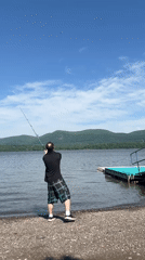 Man fishes from pebble beach at Newburgh lake