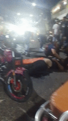 Emergency responders attend woman near motorcycle in Tinaquillo street