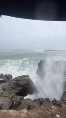 Rough seas crash against rocky coastline in Arica, Chile