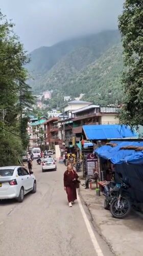 Daily life unfolds on Bhagsu streets near temple