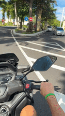 Motorcycle rider navigates morning streets in Kuta Selatan