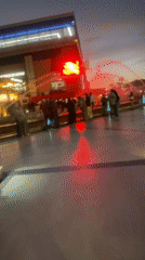 Crowds gather around colorful fountain display during Marrakesh sunset
