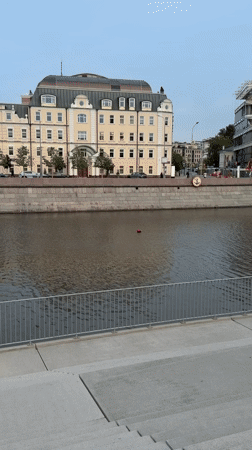 Moscow riverfront construction and street life captured in afternoon