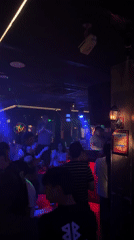 Young adults gather at dimly lit nightclub in Liangjiang