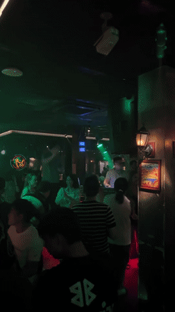 Young adults gather at dimly lit nightclub in Liangjiang