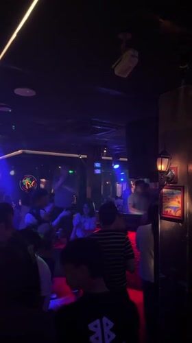 Young adults gather at dimly lit nightclub in Liangjiang
