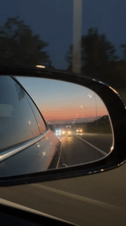 Evening drive through Kazan captured in side mirror reflection