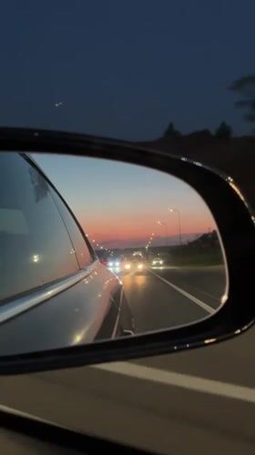 Evening drive through Kazan captured in side mirror reflection