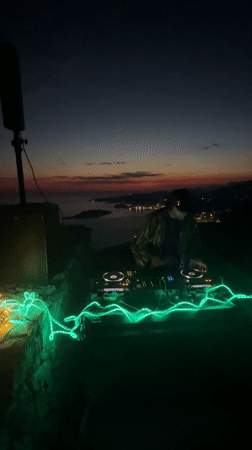 DJ performs sunset set overlooking Montenegro coastline