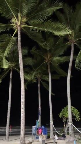 Couple enjoys evening beach time in Patong, Thailand