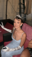 Woman in formal gown and tiara spotted on outdoor couch