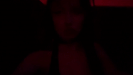 Person filmed in red lighting in Milan